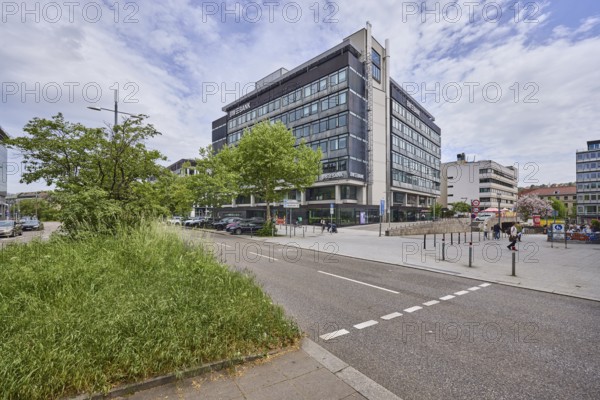 Baden-Württembergische Bank, BW-Bank, modern architecture, street, pedestrian crossing, general architecture, centre island, bollards, trees, pedestrians as accessories, milky blue sky, diffuse light, Theodor-Heuss-Straße, Stuttgart, state capital, urban district of Stuttgart, Baden-Württemberg, Germany