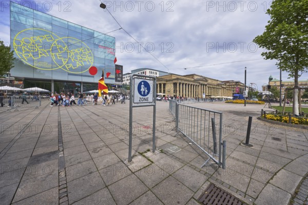 Art museum Stuttgart, modern architecture, Architekturbüro Hascher Jehle, pedestrian zone, traffic sign, barrier railing, barrier bollard, trees, pedestrians as accessories, milky blue sky, diffuse light, slightly sunny, Königstraße, Stuttgart, state capital, city district of Stuttgart, Baden-Württemberg, Germany