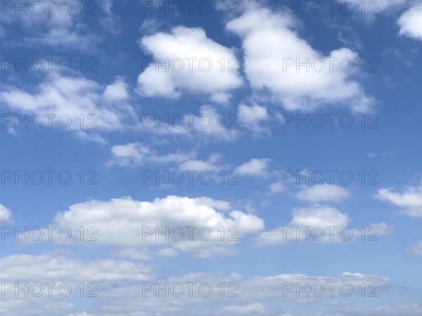 Different types of white cumulus clouds under blue sky above Cirrocumulus clouds below Altocumulus clouds below Stratocumulus clouds, international
