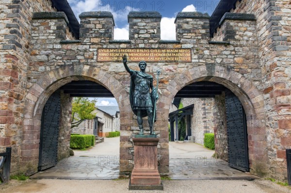 Statue of ancient Roman emperor Antoninus Pius with right arm raised to Roman salute Saluto romano in front of main portal entrance to reconstructed Roman fort Saalburg, Bad Homburg, Hesse, Germany