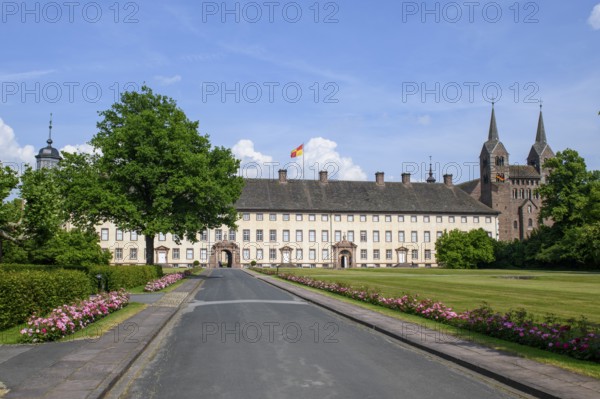 View across driveway with flower-lined street to Corvey Castle and Monastery, Höxter, North Rhine-Westphalia, Germany