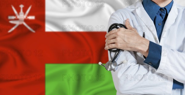 Doctor with stethoscope on Oman flag. Doctor holding stethoscope on Oman flag