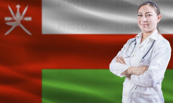 Female doctor on Oman flag. Doctor with crossed arms on Oman flag. Oman health and care concept