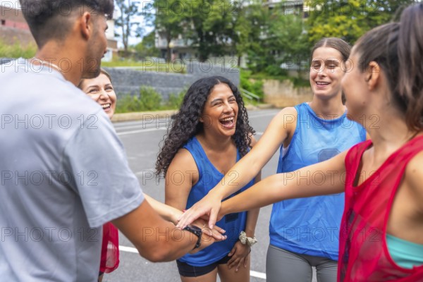 Young soccer players are gathering in a circle, joining their hands together, symbolizing their unity, teamwork, and sportsmanship before a soccer match