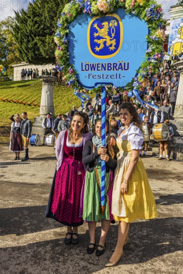 The landlady of the Löwenbräu festival tent in company with flower-decorated table, Wiesnwirte Platzkonzert, Festwiese, Theresienwiese, Oktoberfest, Munich, Upper Bavaria, Bavaria, Germany