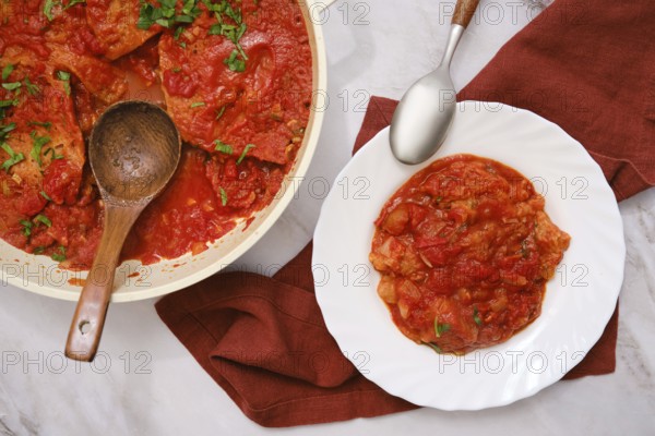 Close-up overhead view of Italian tomato and bread soup Pappa al pomodoro in a pot and a plate
