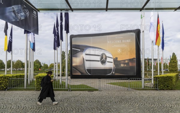 Entrance area at the exhibition halls. IAA MOBILITY in Munich. The Autoshow presents itself as a holistic mobility trade fair. But cars are still the centre of attention. Advertising banner of the Mercedes brand. Munich, Bavaria, Germany