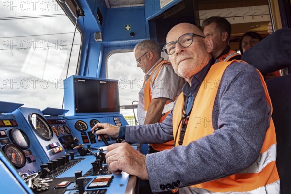 A minister as train driver: Winfried Hermann (MdL, Bündnis 90-Die Grünen, Minister of Transport BW) in the driver's cab of a railcar. Test run on the new line between Wendlingen and the new airport railway station. The section of the Stuttgart-Ulm high-speed line is due to come online at the end of 2026. It is a central component of the Stuttgart 21 railway project. Stuttgart, Baden-Württemberg, Germany