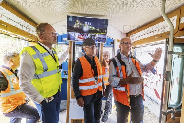 First test run on the new railway line between Wendlingen and the airport. Winfried Hermann (centre, MdL, Greens, Transport Minister BW) and Olaf Drescher (right, Project Manager of Stuttgart 21 and the DB Stuttgart-Ulm project) then inspected the construction progress at the new airport railway station. On the left Carsten Poralla, Managing Director Non-Aviation Stuttgart Airport. Stuttgart, Baden-Württemberg, Germany