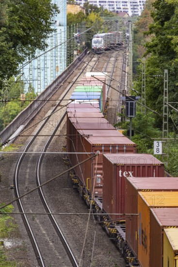 Two goods trains underway on the Schuster railway in front of the Münster cogeneration plant. Stuttgart, Baden-Württemberg, Germany