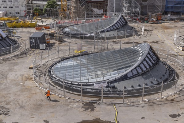 Stuttgart 21 construction site at the main station. View of the glass eyes of the future underground through station. 27 light eyes will illuminate the new underground through station. Façade construction specialist Seele is currently installing the glass, steel and aluminium construction in a complex process. The light eyes have a diameter of up to 21 metres. Stuttgart, Baden-Württemberg, Germany