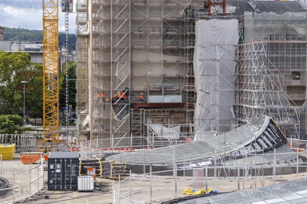 Stuttgart 21 construction site at the main station. View of the glass eyes of the future underground through station. Construction workers at the station tower of the Bonatzbau. Stuttgart, Baden-Württemberg, Germany