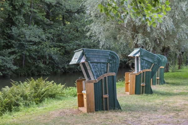 Three green beach chairs by a river, Ahaus-Alstätte, Münsterland, North Rhine-Westphalia, Germany
