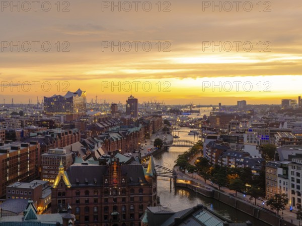Aerial view of the Speicherstadt Hamburg with evening lighting and view over the harbour with Elbphilharmonie, Hamburg, Germany