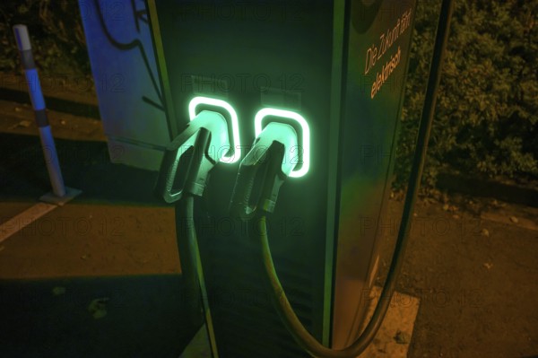 Evening-lit charging station for electric cars in a car park, Erlangen, Middle Franconia, Bavaria, Germany