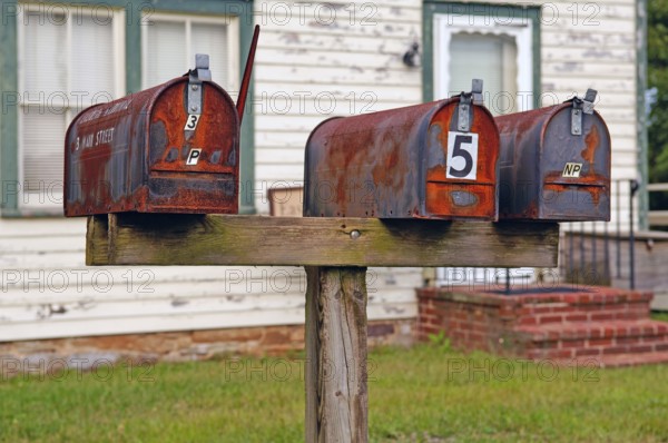 Rusted, private mailboxes in front of a house, Walpack, New Jersey, USA