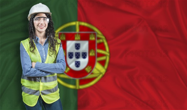 Young female construction engineer with Portugal flag. Portrait of smiling female engineer with Portuguese flag in background