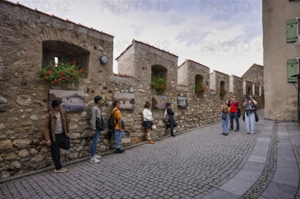 Tourists, visitors, Asians, taking pictures at the city wall, castle wall with paintings, Laufen Castle, Rhine Falls Schaffhausen, waterfall, Laufen-Uhwiesen, Canton Schaffhausen, Switzerland