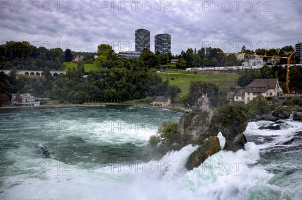 Rhine Falls Schaffhausen, waterfall, centre rock, viewing platform, visitors, tourists, behind it Neuhausen, Canton Schaffhausen, Switzerland
