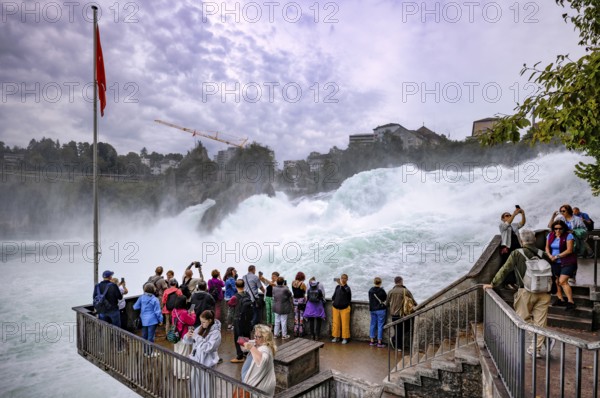 Visitors, tourists, taking selfies with smartphone, viewing platform Känzeli, Rhine Falls Schaffhausen, waterfall, behind Neuhausen, Canton Schaffhausen, Switzerland