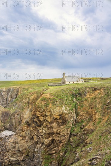 Chapelle Saint-They on the edge of a steep cliff a historical building on the dramatic french coast, Pointe du Van, Crozon Peninsula, Bretagne, France
