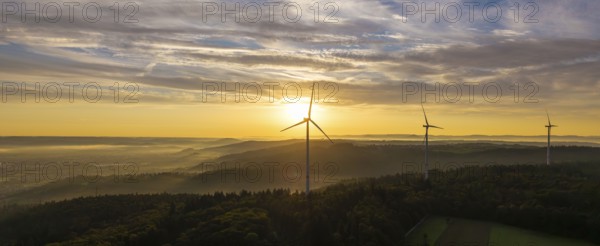 A wide panorama with wind farms at dawn, the sun rises over the landscape, near Schorndorf, Remstal, Rems-Murr-Kreis, Baden-Württemberg, Germany