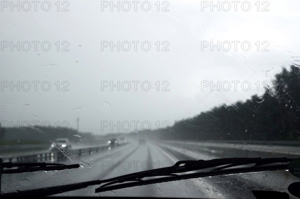 Car journey in rainy weather, summer, Germany