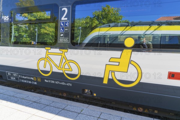 Train with bicycle and wheelchair symbols on a sunny platform surface, battery Electric train with green electricity, Siemens Mireo Plus B, Freudenstadt, Germany