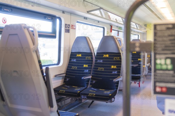 Rows of blue and yellow seats in a clean train compartment, battery Electric train with green electricity, Siemens Mireo Plus B, Freudenstadt, Germany