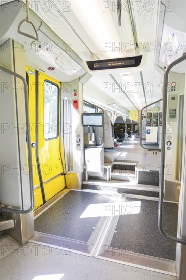 Modern entrance in the train with yellow doors and brightly lit interior, battery Electric train with green electricity, Siemens Mireo Plus B, Freudenstadt, Germany