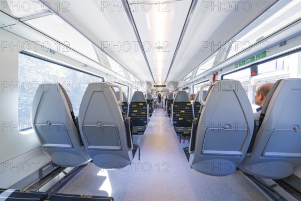 Spacious and modern train compartments with rows of window seats, battery Electric train with green electricity, Siemens Mireo Plus B, Freudenstadt, Germany