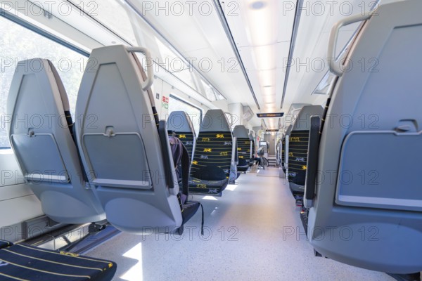 Modern train interior with rows of seats along large windows, battery Electric train with green electricity, Siemens Mireo Plus B, Freudenstadt, Germany