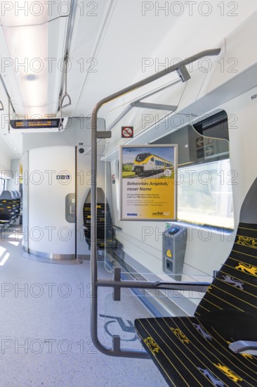 Train compartment with poster on the wall and empty seats in daylight, battery Electric train with green electricity, Siemens Mireo Plus B, Freudenstadt, Germany