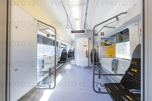 Modern interior of a train with blue seats and plenty of daylight, battery Electric train with green electricity, Siemens Mireo Plus B, Freudenstadt, Germany