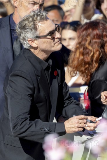 Venice, Italy - 3 September 2025: Joaquin Phoenix signing autographs during the Red Carpet of - The Voice Of Hind Rajab - during the 82nd Venice International Film Festival