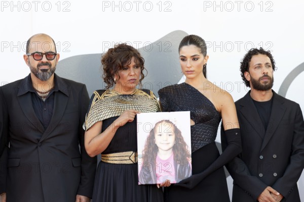 Venice, Italy - 3 September 2025: Kaouther Ben Hania and Saja Kilani with a portrait of five-year-old Palestinian girl Hind Rajab, who was killed by the Israeli army in the Gaza Strip in January 2024, during the red carpet of - The Voice Of Hind Rajab - during the 82nd Venice International Film Festival