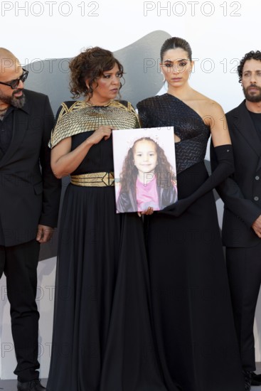 Venice, Italy - 3 September 2025: Kaouther Ben Hania and Saja Kilani with a portrait of five-year-old Palestinian girl Hind Rajab, who was killed by the Israeli army in the Gaza Strip in January 2024, during the red carpet of - The Voice Of Hind Rajab - during the 82nd Venice International Film Festival