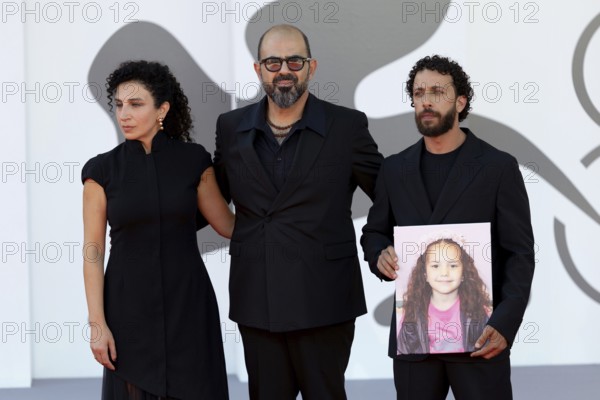 Venice, Italy - 3 September 2025: Clara Khoury, Amer Hlehel, Motaz Malhees with a portrait of five-year-old Palestinian girl Hind Rajab, who was killed by the Israeli army in the Gaza Strip in January 2024, during the red carpet of - The Voice Of Hind Rajab - during the 82nd Venice International Film Festival