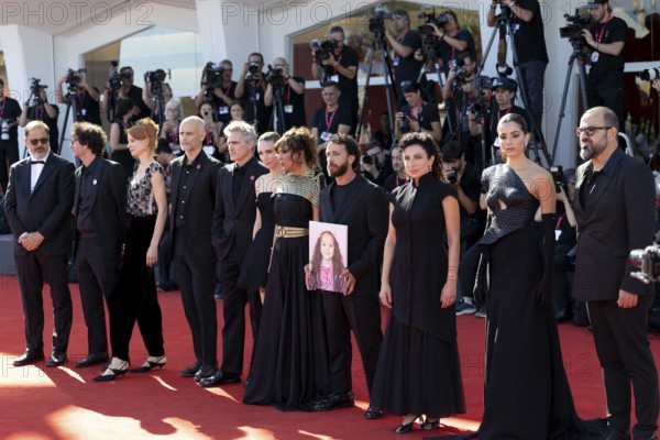 Venice, Italy - 3 September 2025: Nadim Cheikhrouha, Odessa Rae, James Wilson, Joaquin Phoenix, Mara Rooney, Kaouther Ben Hania, Motaz Malhees and Clara Khoury with a portrait of five-year-old Palestinian girl Hind Rajab, who was killed by the Israeli army in Gaza in January 2024, during the Red Carpet of - The Voice Of Hind Rajab - during the 82nd Venice International Film Festival