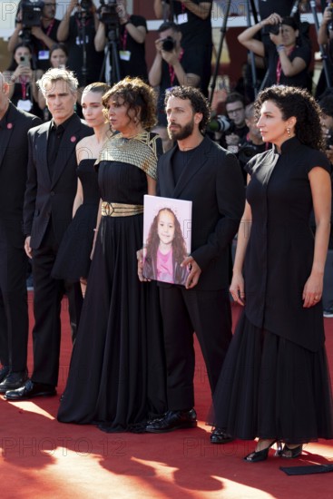 Venice, Italy - 3 September 2025: Joaquin Phoenix, Rooney Mara, Kaouther Ben Hania, Motaz Malhees, Clara Khoury with a portrait of the five-year-old Palestinian girl Hind Rajab, who was killed by the Israeli army in Gaza in January 2024, during the Red Carpet of - The Voice Of Hind Rajab - during the 82nd Venice International Film Festival