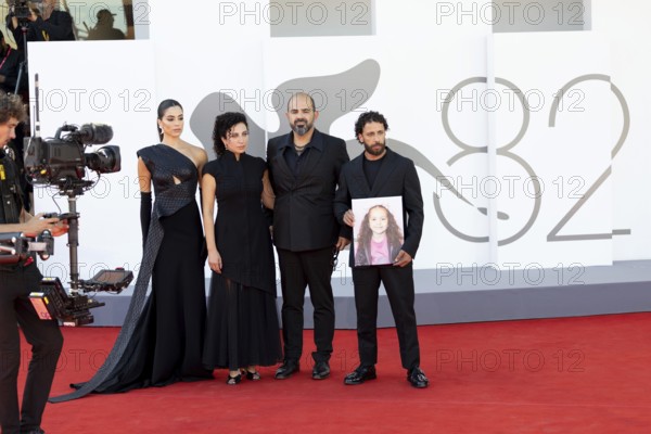 Venice, Italy - 3 September 2025: Saja Kilani, Clara Khoury, Amer Hlehel, Motaz Malhees with a portrait of five-year-old Palestinian girl Hind Rajab, who was killed by the Israeli army in the Gaza Strip in January 2024, during the red carpet of - The Voice Of Hind Rajab - during the 82nd Venice International Film Festival