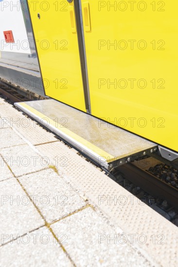 Close-up of a step on the yellow train belt line on the platform, battery Electric train with green electricity, Siemens Mireo Plus B, Freudenstadt, Germany