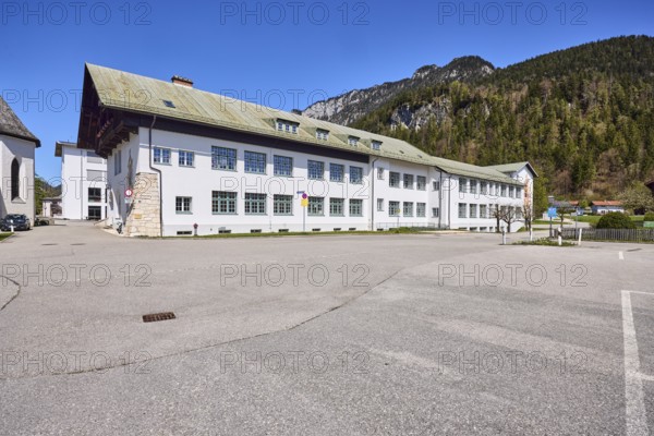 Primary and secondary school Bischofswiesen, vocational school for child care, building, mountains, coniferous forest, blue sky, cloudless, intersection Rathausplatz with Schulstraße, Bischofswiesen, district Berchtesgadener Land, Bavaria, Germany