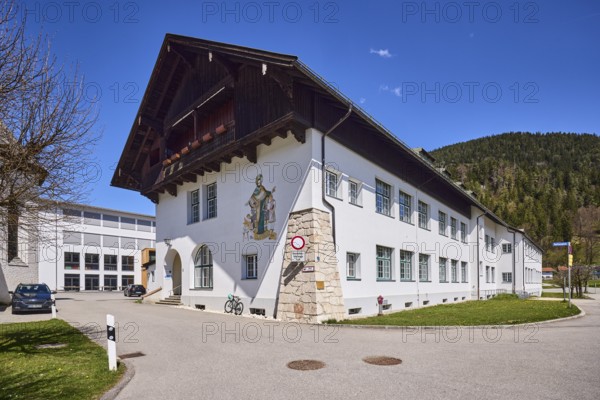 Vocational school for child care, primary and secondary school Bischofswiesen, buildings, streets, primary school, secondary school, mountains, coniferous forest, blue sky, cloudless, intersection Rathausplatz with Schulstraße, Bischofswiesen, district Berchtesgadener Land, Bavaria, Germany