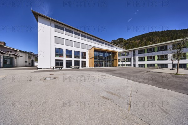 Primary and secondary school Bischofswiesen, primary school, secondary school, building, schoolyard, mountains, coniferous forest, blue sky, town hall square, Bischofswiesen, district Berchtesgadener Land, Bavaria, Germany