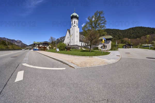Parish church Herz-Jesu Bischofswiesen, church, trees, lawn, hill, coniferous forest, blue sky, cirrostratus clouds, crossing of federal road 20 with town hall square, Bischofswiesen, district Berchtesgadener Land, Bavaria, Germany