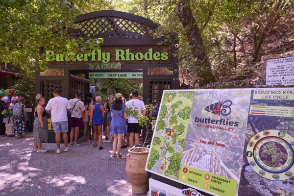 Entrance to a nature park full of butterflies with visitors and park sign, Butterfly Valley, Spanish flag, Jersey tiger (Callimorpha quadripunctaria rhodosensis), Rhodes, Dodecanese, Greek Islands, Greece