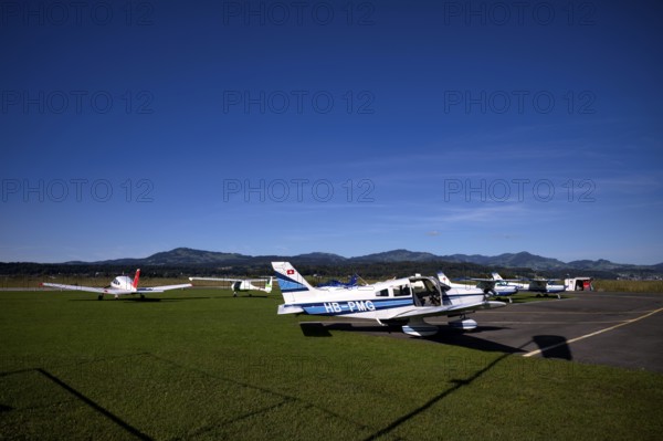 Pipistrel Velis Club on the right with aircraft registration HB-NPP stands next to Piper Archer II HB-PPY on the left and PA28 Archer II 180 HP HB-PMG, centre Wangen-Lachen airfield, LSPV, Canton Schwyz, Switzerland