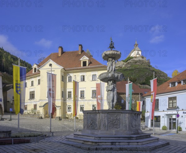 Main square with fountain in the background Filialkirche St. Peter am Petersberg, Friesach, Carinthia, Austria