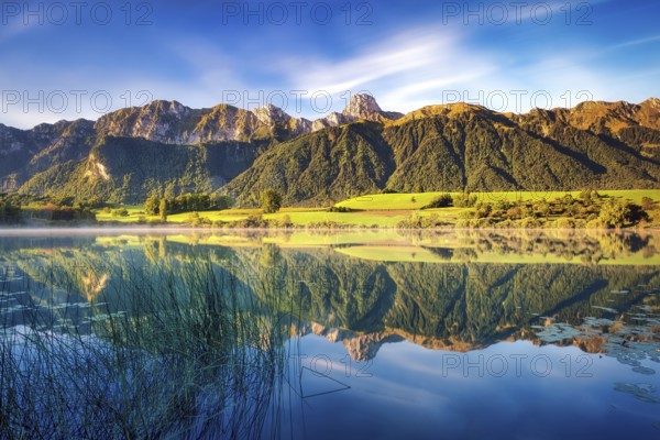 Stockhorn mountain reflected in the Uebeschi lake in the morning light, Gürbetal, Canton Bern, Switzerland